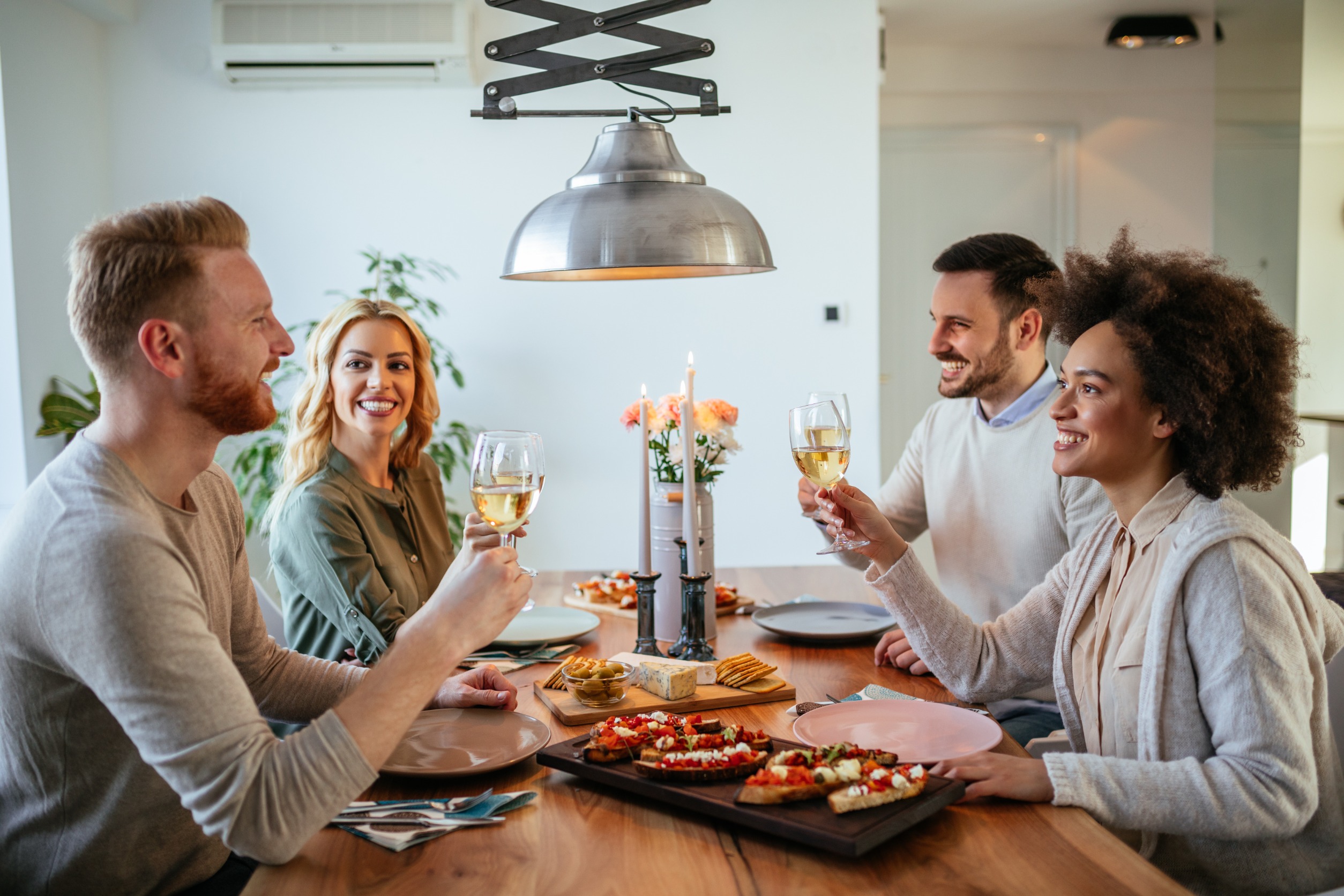 four people enjoying a dinner party